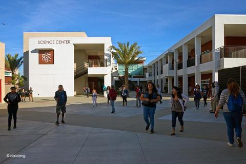 Completed school science center with students in the courtyard